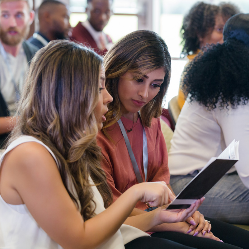 Attendees reviewing conference materials